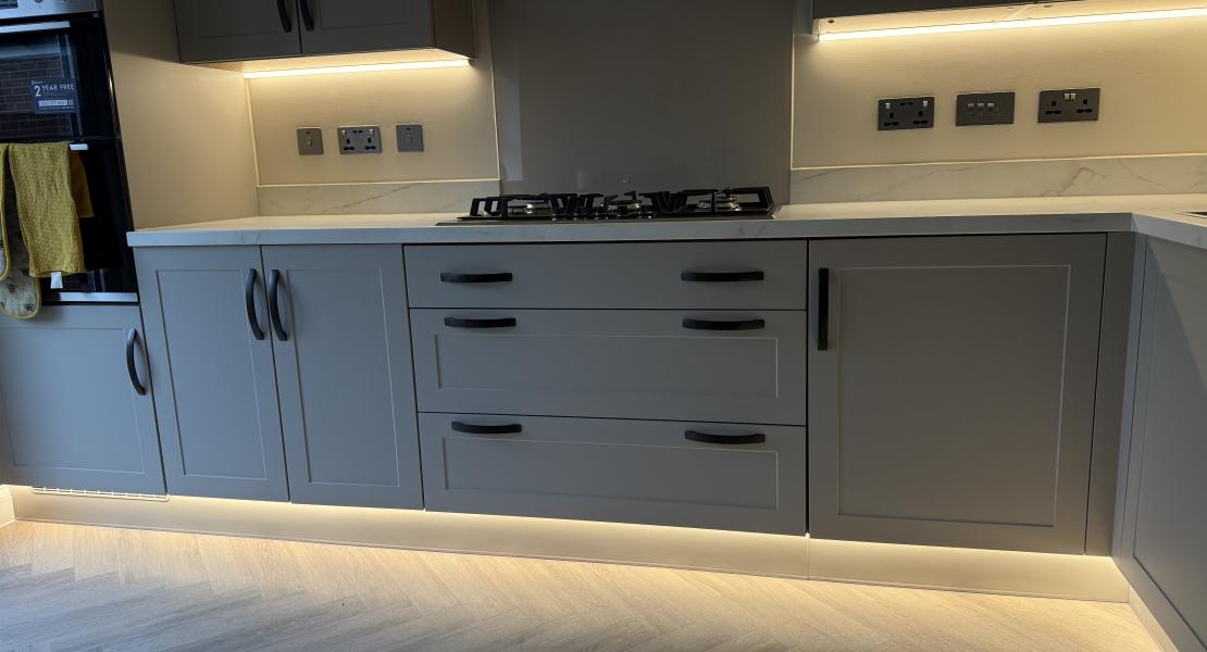 Finished kitchen with LED under-cabinet lights and plinth lighting installed during kitchen electrical work in Norwich.