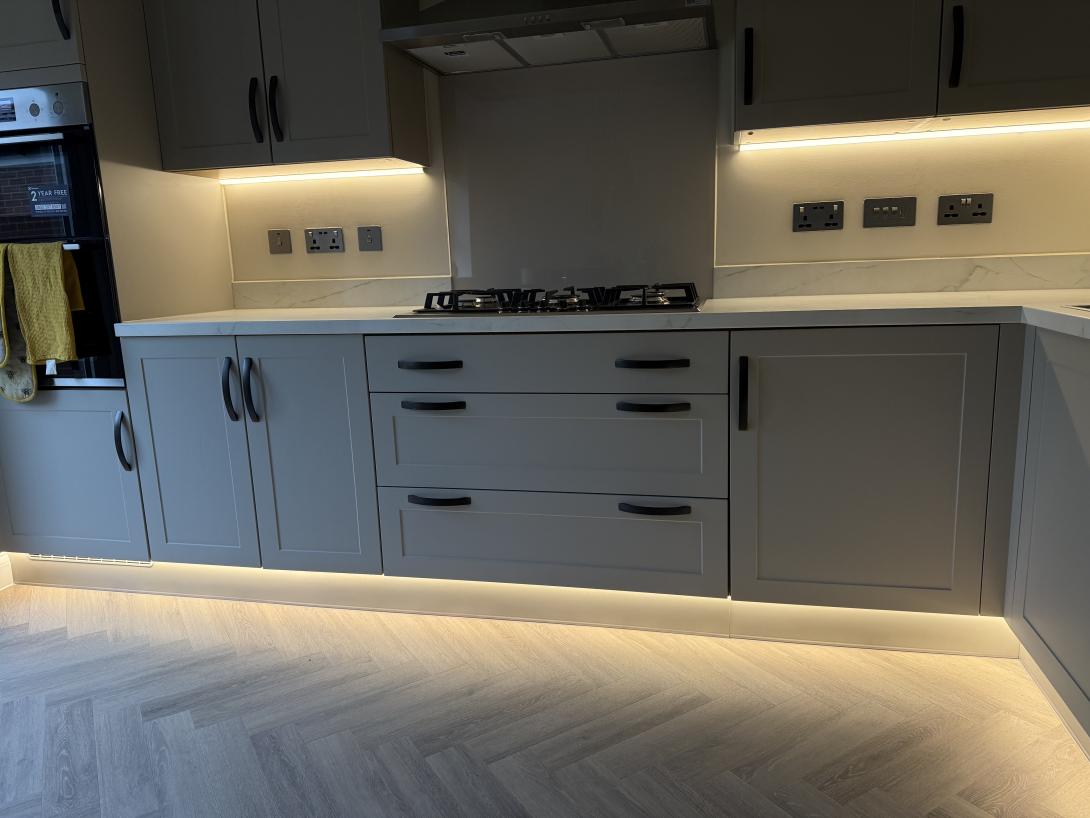 Finished kitchen with LED under-cabinet lights and plinth lighting installed during kitchen electrical work in Norwich.